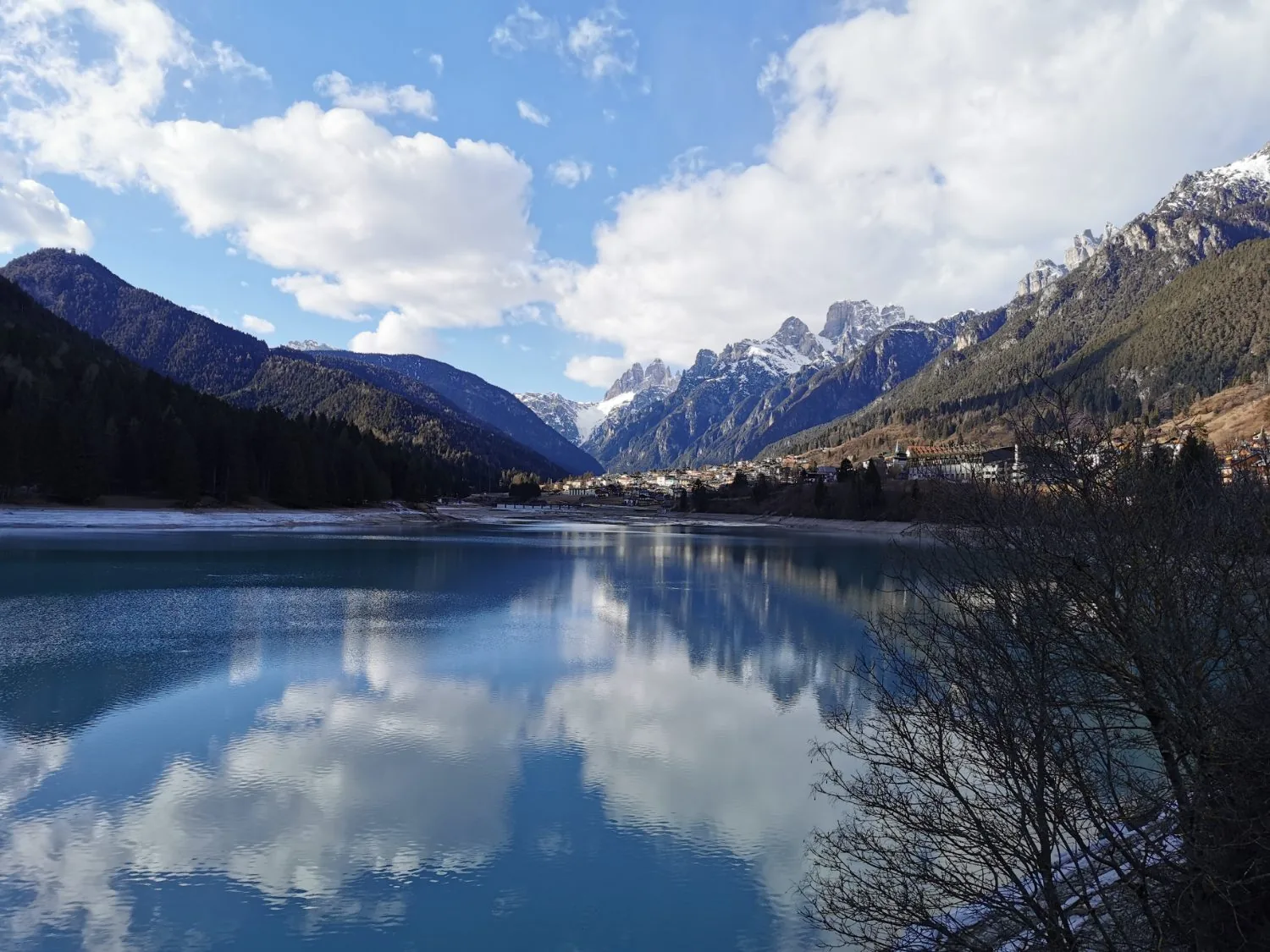 Snow-capped Dolomite peaks mirrored in a still alpine lake