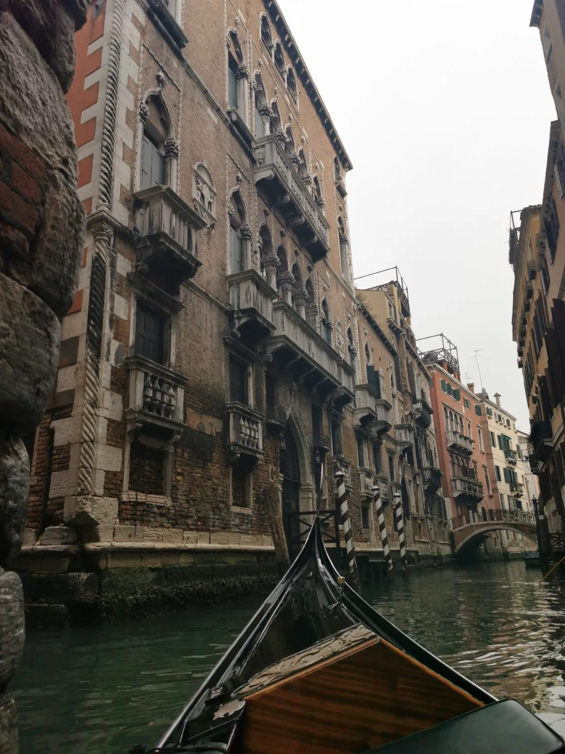 The view from a gondola drifting through a quiet Venetian canal